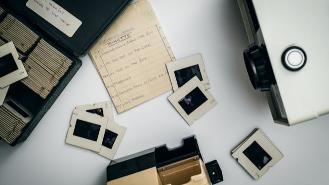 overhead view of old-fashioned slides and projector, indicating an archive