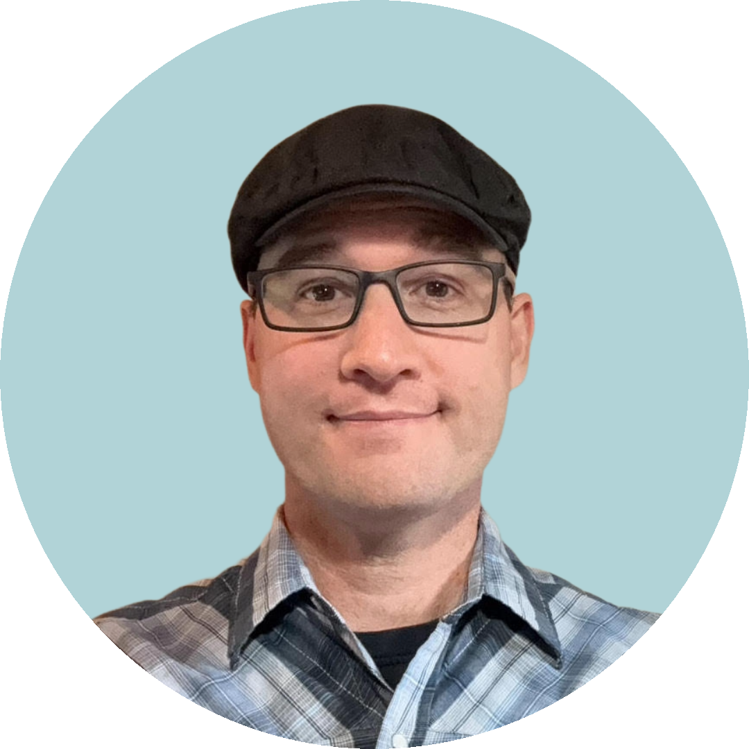 a professional portrait of a man wearing a hat and glasses